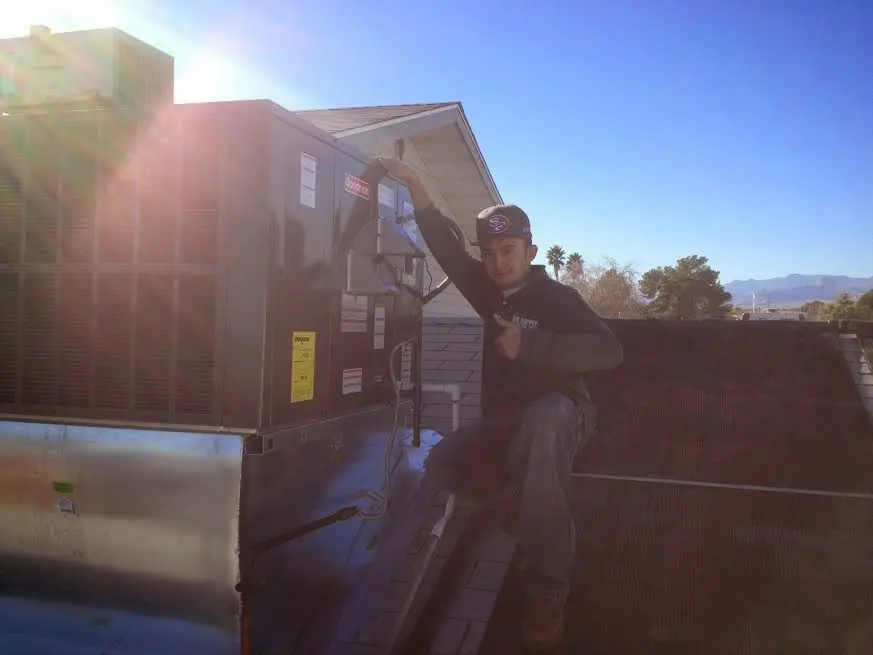 HVAC technician performing Heat Pump Repair on a rooftop unit in Mount Juliet